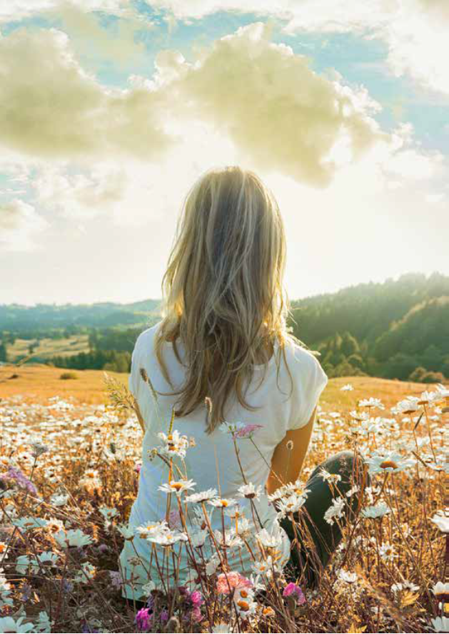 Donna di schiena in un campo di fiori